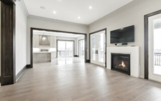 Hall's Lake Estates Luxury Model Home living room with gas fireplace